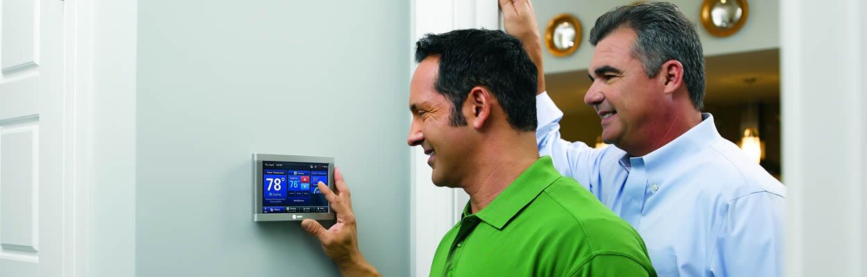 Trane Tech Showing Customer How To Use Thermostat
