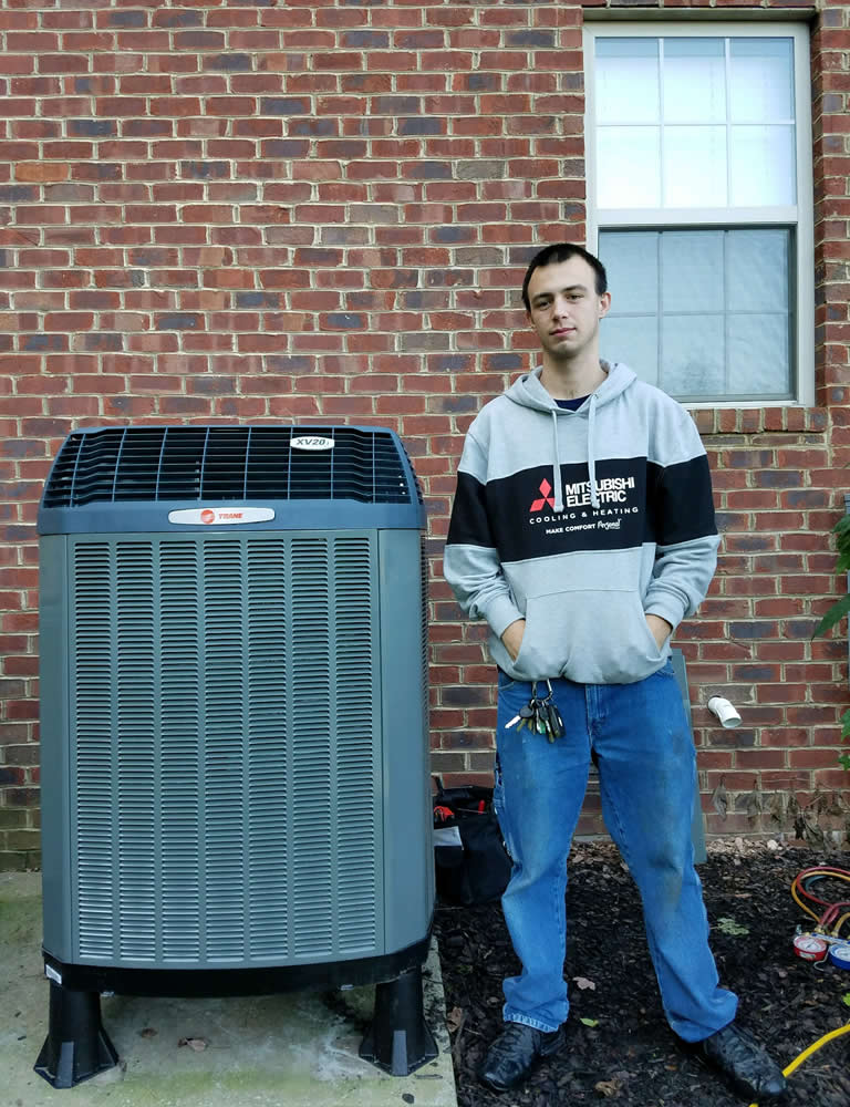 Ej Thompson Tech Standing Next To Hvac Unit